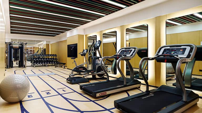 Fitness center with treadmills, yoga ball and free weights area