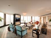 Presidential Suite Lounge Area with Wall Mounted HDTV, Coffee Table, Armchairs and Sofas