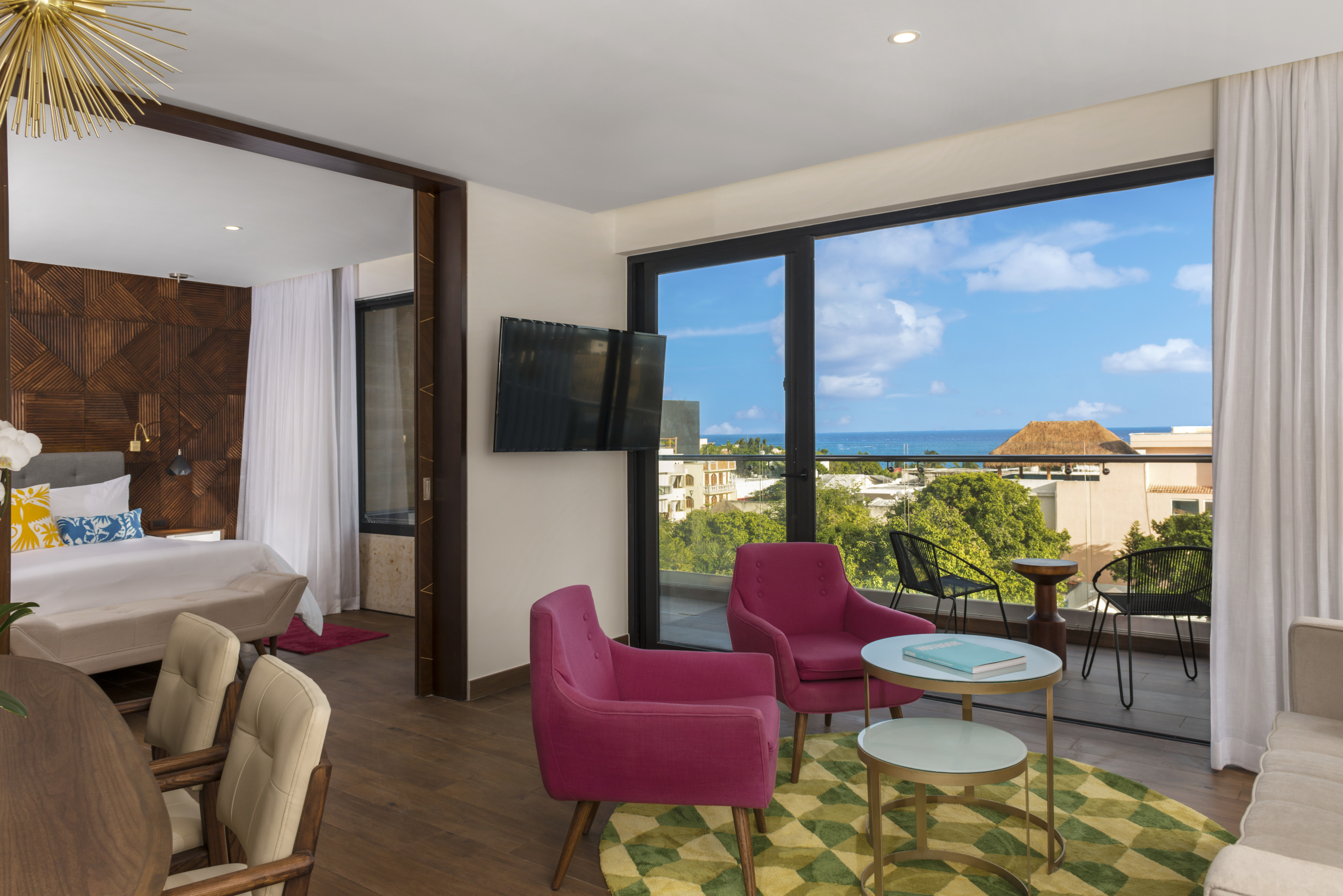 Living Area of One Bedroom Suite with HDTV and City and Ocean View