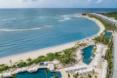 Aerial View of Hilton Tulum Hotel Exterior with Three Large Pool Areas Near the Beach