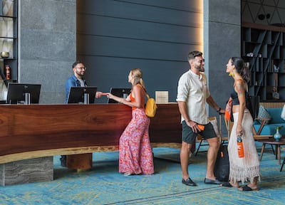 Guests waiting at a stylish reception desk and lounge.