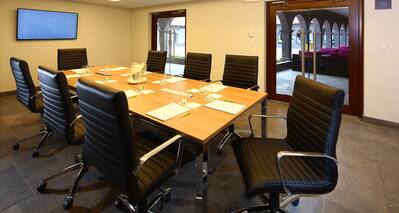 TV and Leather Seating For 8 at Boardroom Table