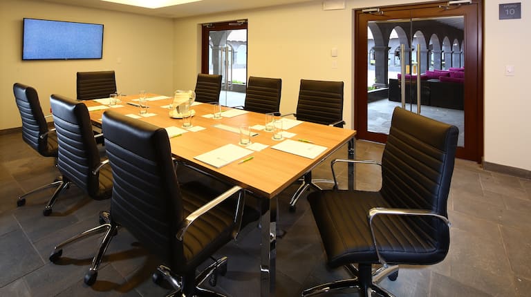 TV and Leather Seating For 8 at Boardroom Table