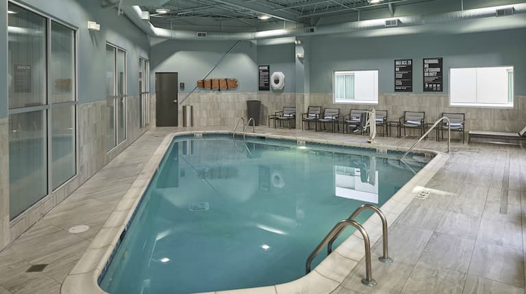 Indoor swimming pool with seating in background