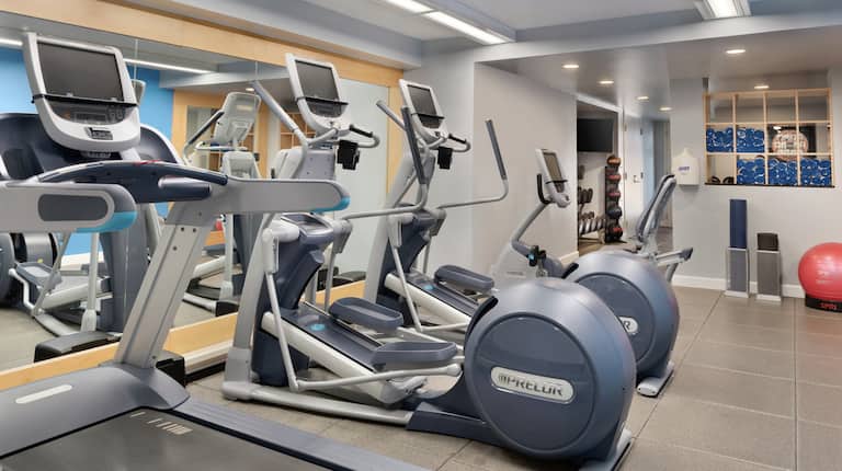Fitness Center with Treadmill, Elliptical Machines, and Red Exercise Ball