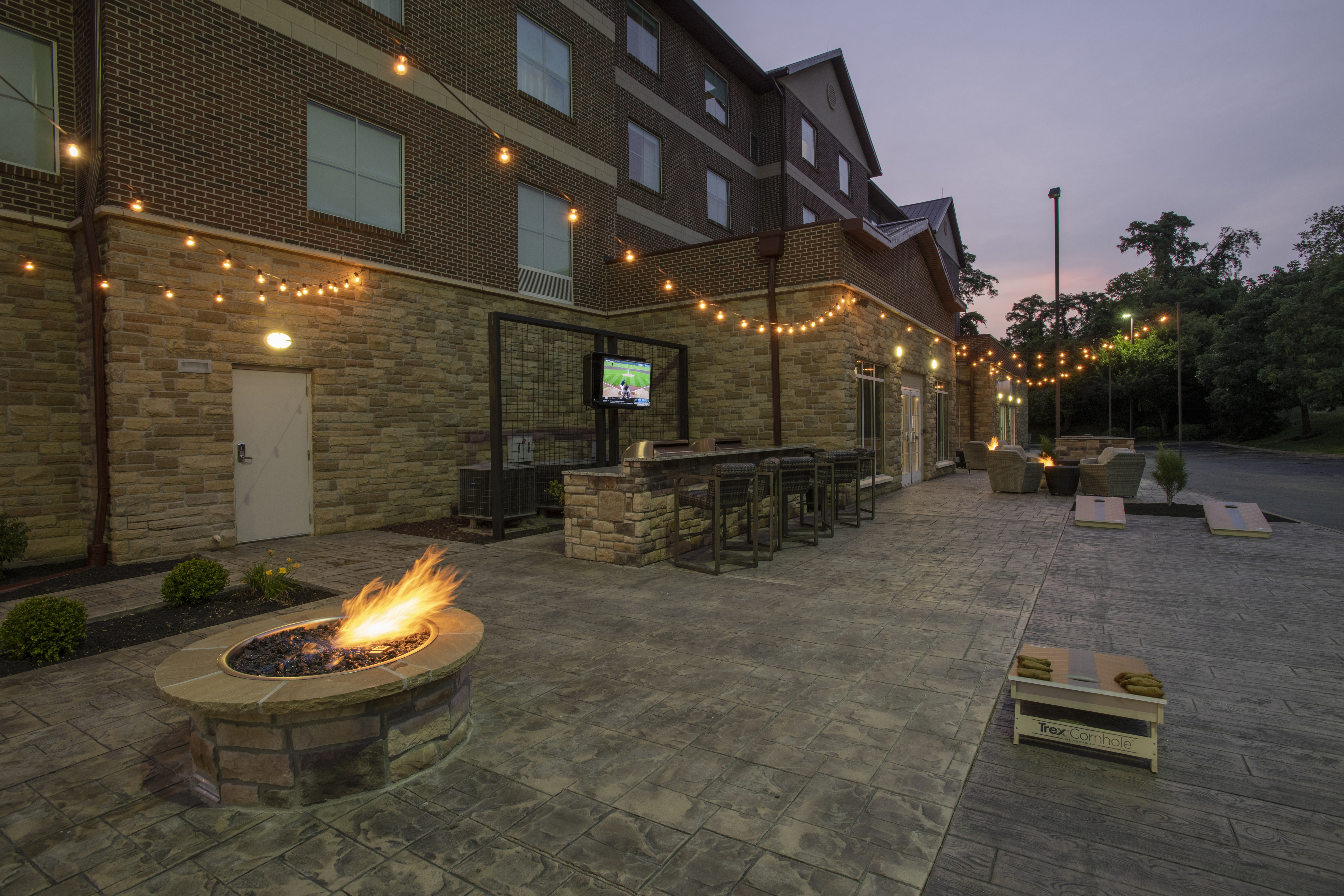 Fire Pit in Outdoor Patio with HDTV and a Large Table