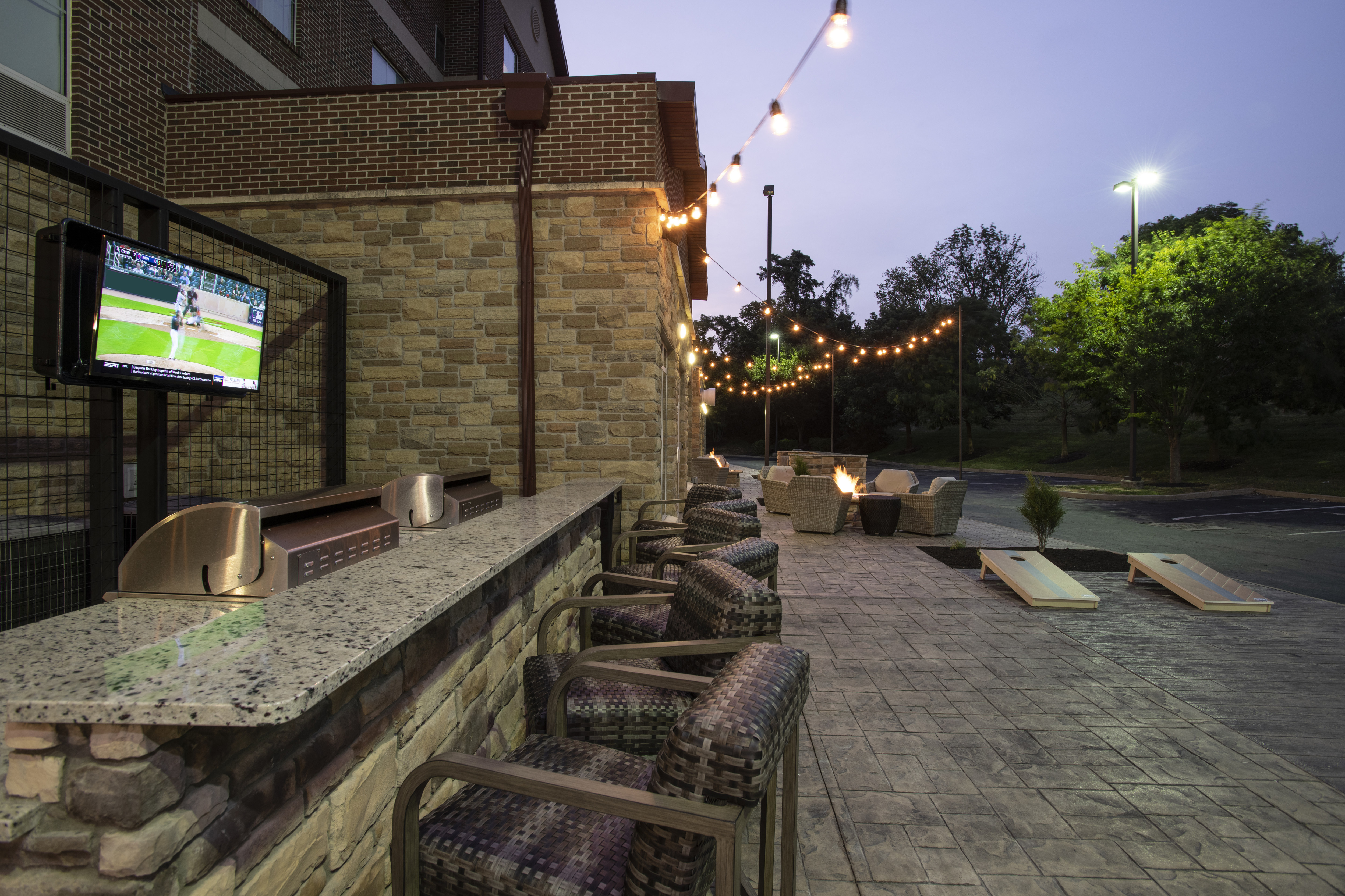 HDTV and Grill Area in Outdoor Patio with Fire Pit 