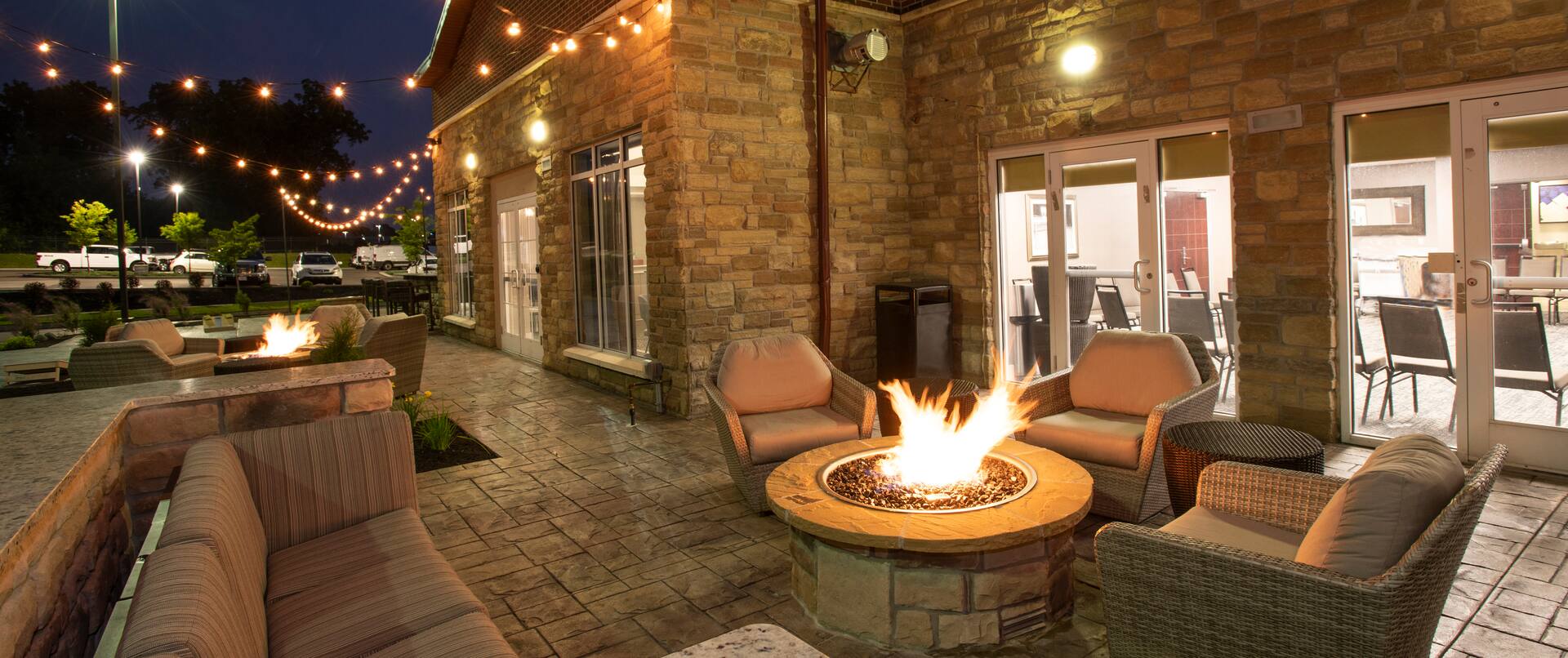 Evening View of Seating Area of Outdoor Patio with Fire Pit