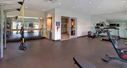 fitness room with exercise machines and weights