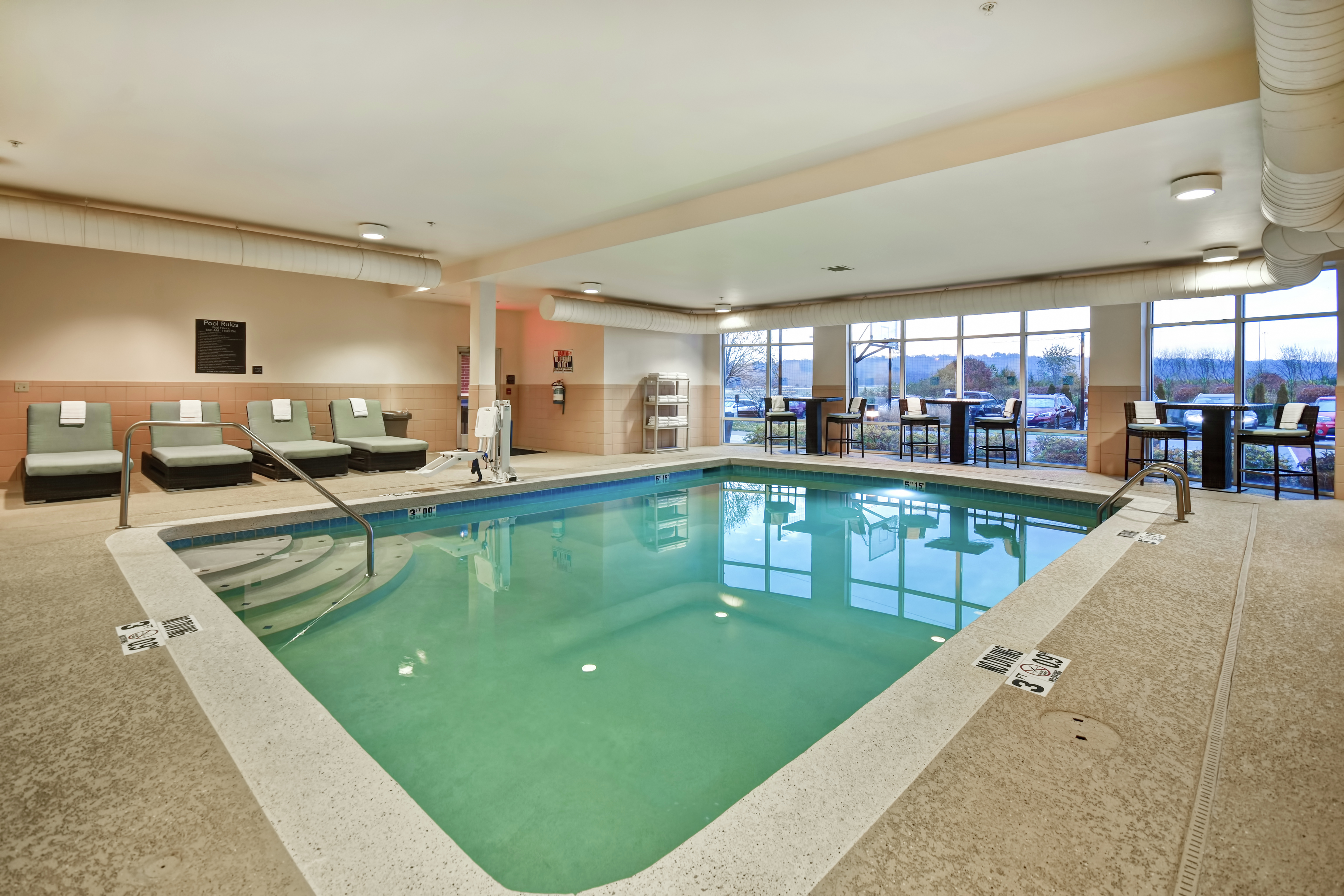Indoor Pool Area with Large Window View of Surrounding Area