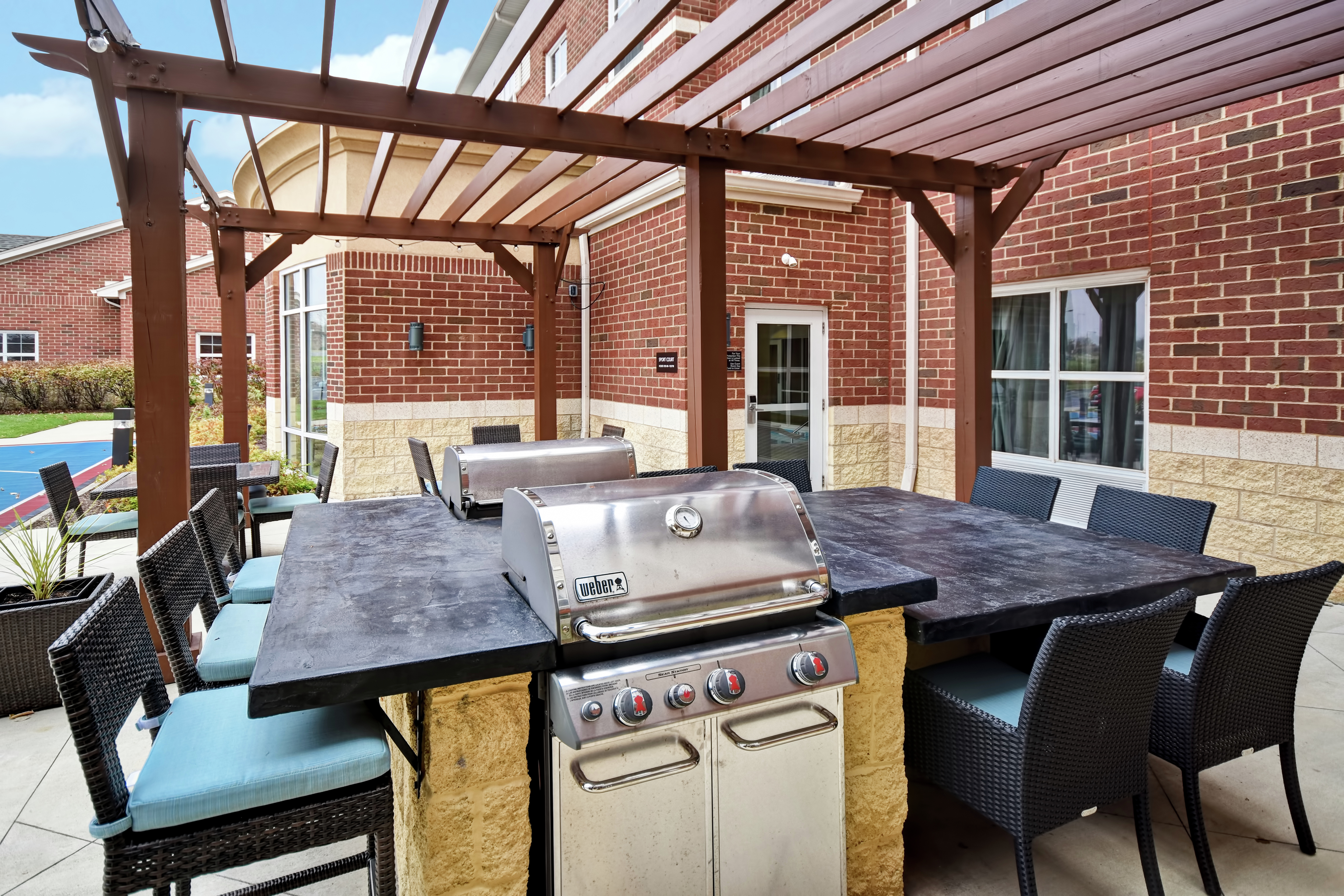 Grill Station and Dining Tables in Outdoor Patio Area