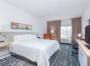 Hotel Guest Room with Large Bed Desk HDTV and Armchair