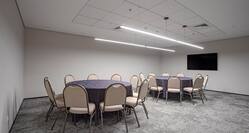 Meeting room with TV and round tables setup