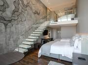 two double beds and stairs in suite