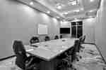 Boardroom with Large Meeting Table, Office Chairs, Whiteboard and Wall Mounted HDTV