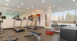 Fitness Center with Treadmills and Weight Benches
