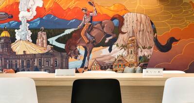 Lobby Eating Space Table and Chairs with Cowboy Mural in Background