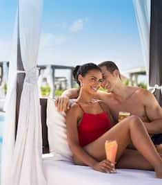 Couple in Cabana at Poolside with Cocktail shot 1