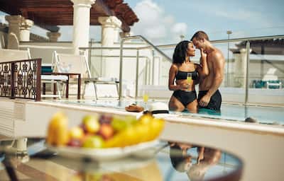 Couple at Rooftop pool with view of fruit