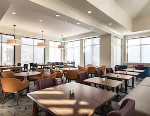 A welcoming breakfast area with an abundance of natural light and comfortable seating