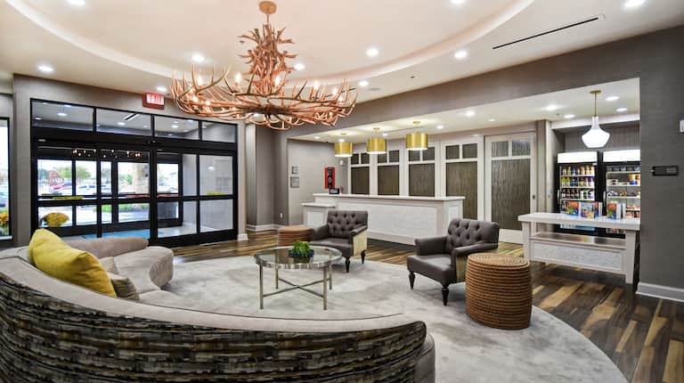 Modernly Styled Front Lobby with Lounge Area, Front Desk, and Suite Shop 
