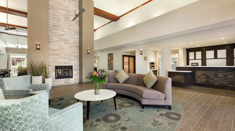 Front Desk and Soft Seating near Fireplace in Lobby 