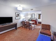 Suite Living Room with Lounge Area, HDTV, Dining Area, and Wet Bar