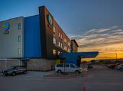 Side View of Tru Hotel Exterior at Sunset