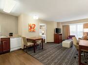 Kitchen, Dining, and Lounge Area in One Queen Bedroom Suite
