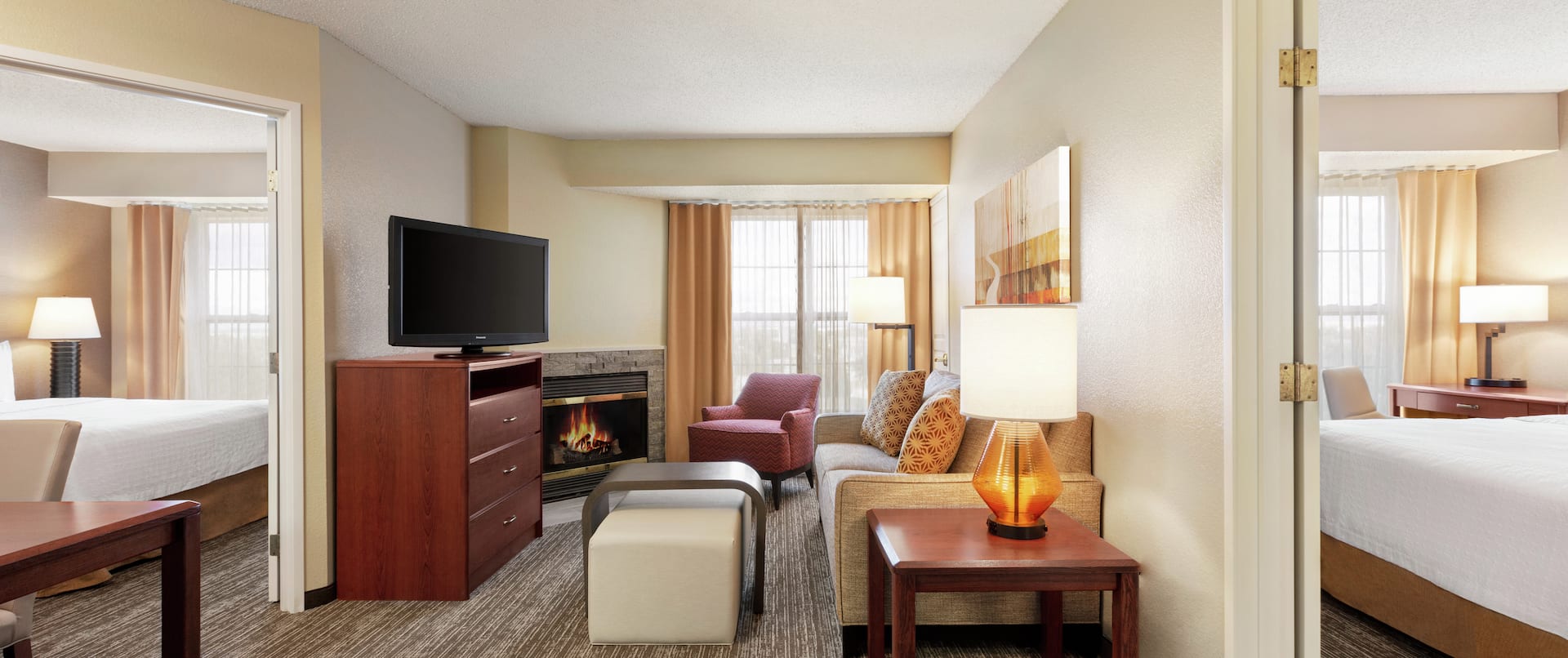 Lounge Area, Fireplace, and TV in Two Queen Bedroom Suite