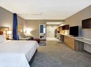Accessible King Guestroom Suite with Bed, Room Technology, Lounge Area, Work Desk, and Kitchenette