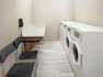 Guest Laudry with washing and drying machines and chairs