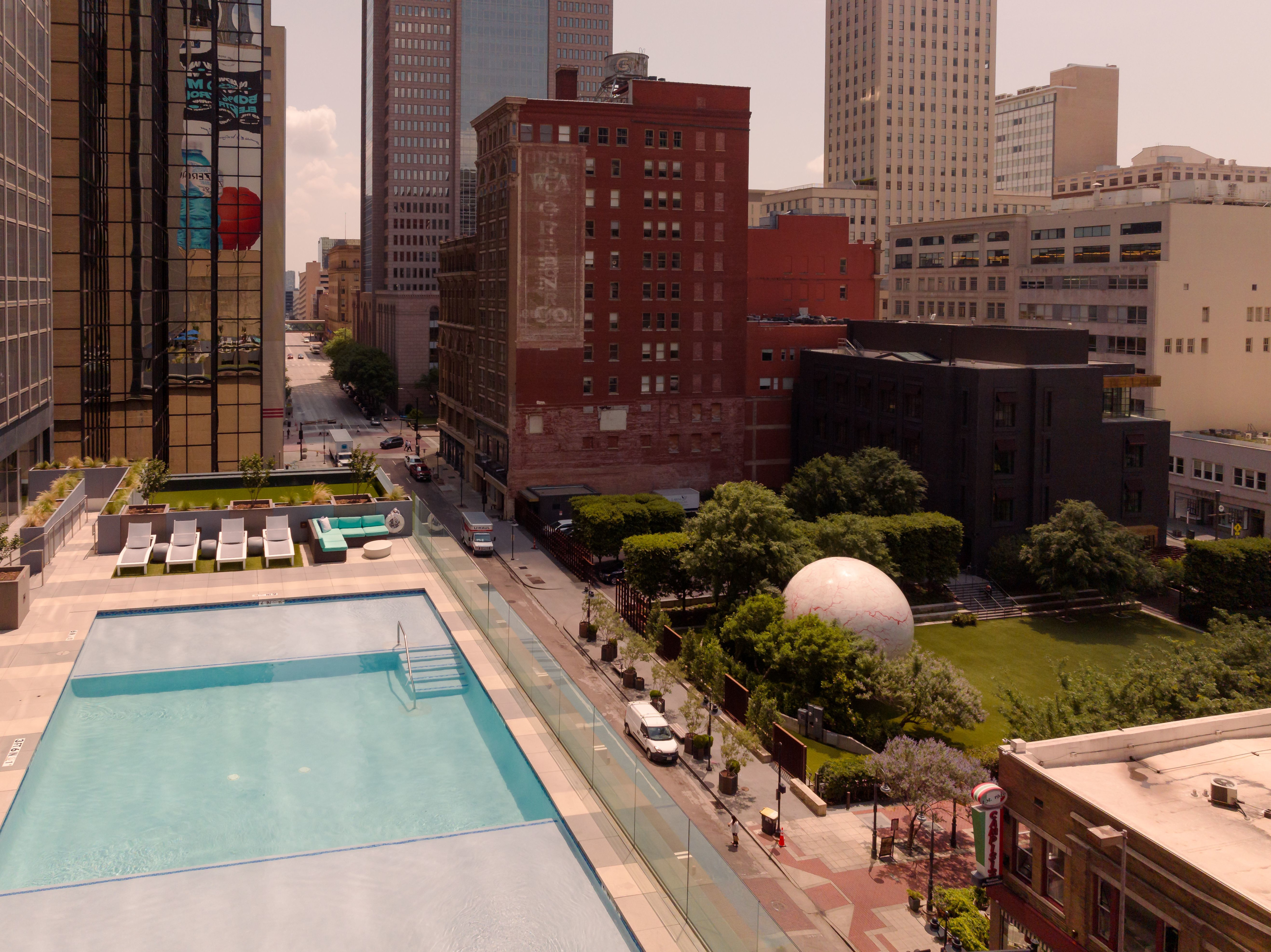 Overhead view of outdoor pool with surrounding buildings