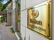 Close Up of Gold Hilton Dallas/Park Cities Sign on Hotel Exterior Wall