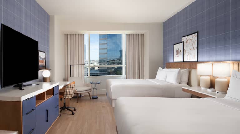 Two Beds, TV and Desk in a Guest Room