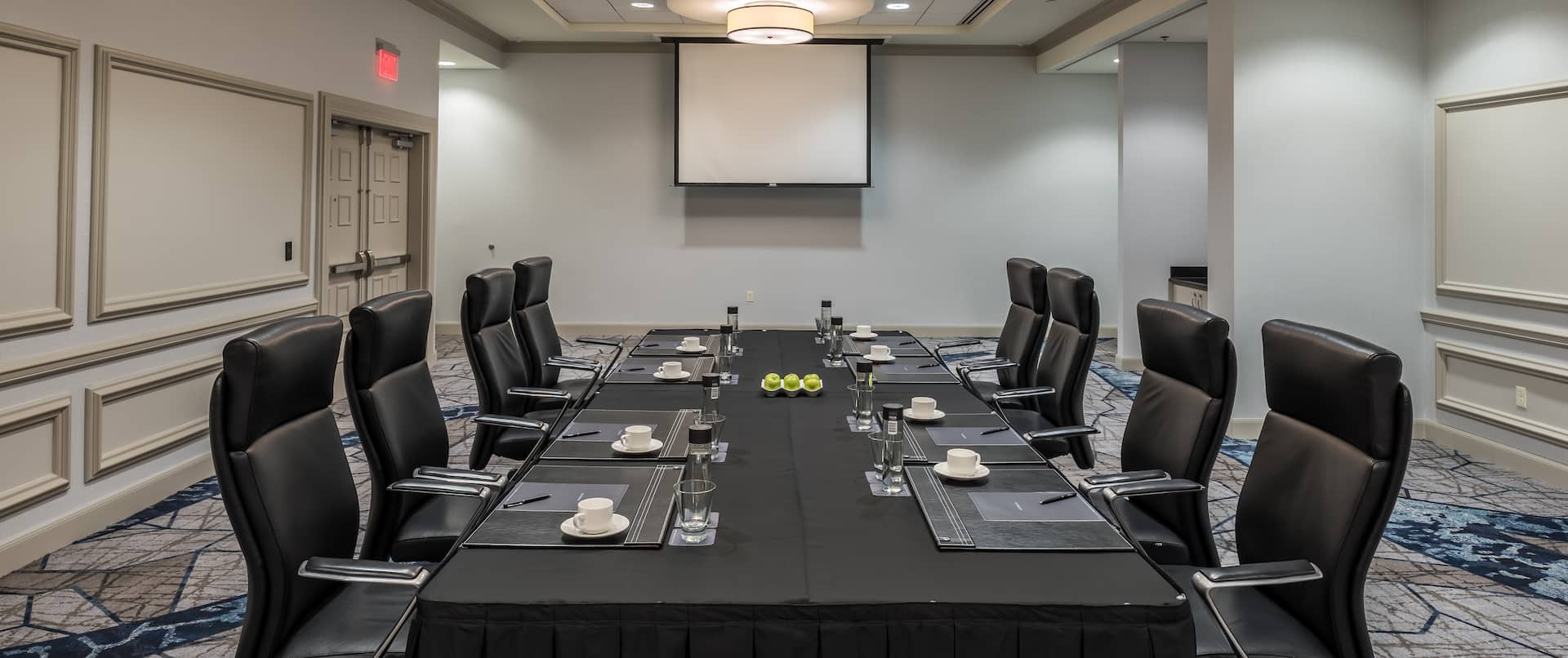 Boardroom with Meeting Table, Office Chairs and Projector Screen