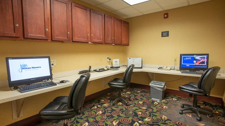 Business Center with Two Desktop Computers, Three Computer Chairs and Printer