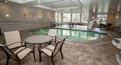 Indoor Pool with Tables, Chairs, and Lounge Chairs