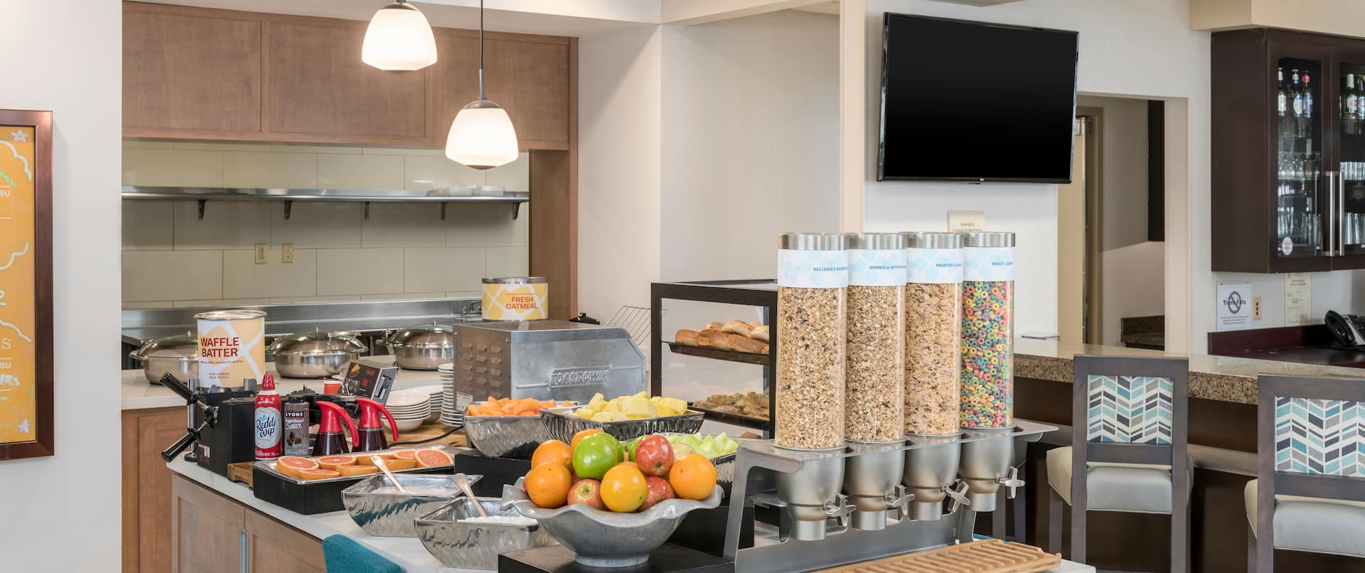 Breakfast Area with Fresh Fruits Cereals and an HDTV