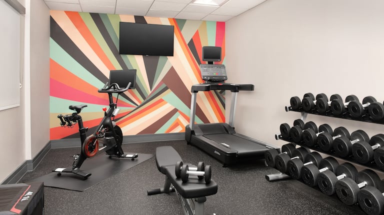 on site fitness center, peloton bike, treadmill, free weights