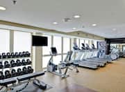 Fitness Center with Treadmills, Dumbbells, Elliptical Machines, Mirror, and Room Technology