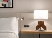 Close-Up of Guestroom Bed with Lamp