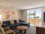Welcoming and bright lounge area with TV and a beautiful partial oceanview