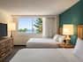 Spacious guest room featuring a beautiful partial oceanview and two queen beds