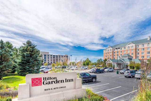 Daytime View of Hotel Exterior, Hilton Garden Inn Sign and Parking