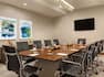 Boardroom with Meeting Table, Office Chairs and Wall Mounted HDTV