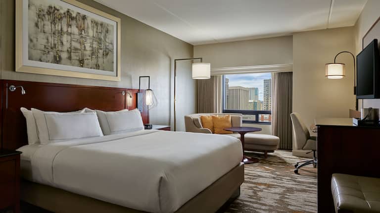 Large Bed HDV and Sofa in Hotel Guest Room with City View