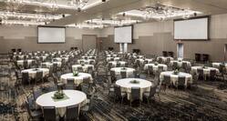 Large Ballroom with Round Tables and Three Projector Screens