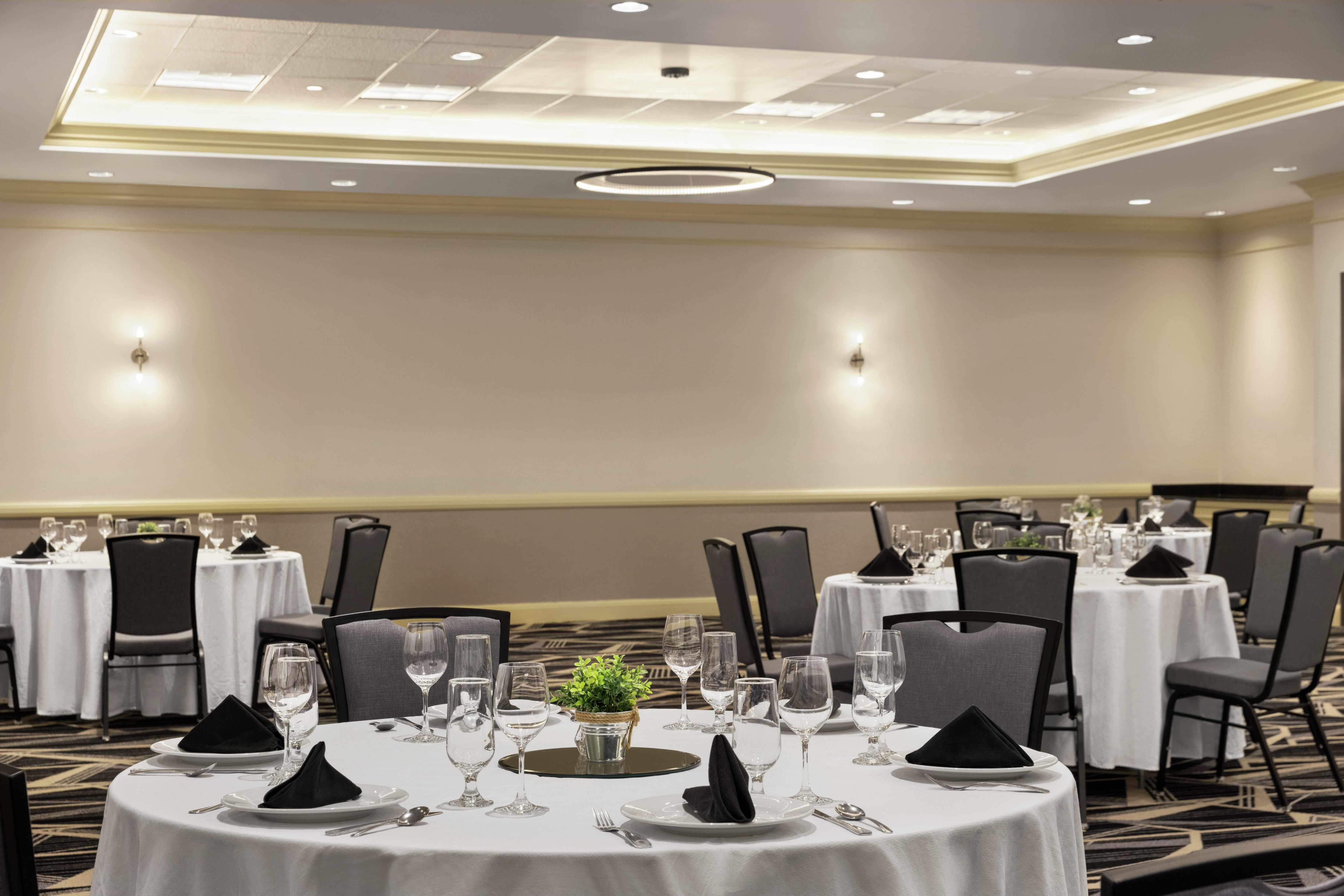Spacious on-site ballroom equipped with banquet style setup for corporate events and functions.