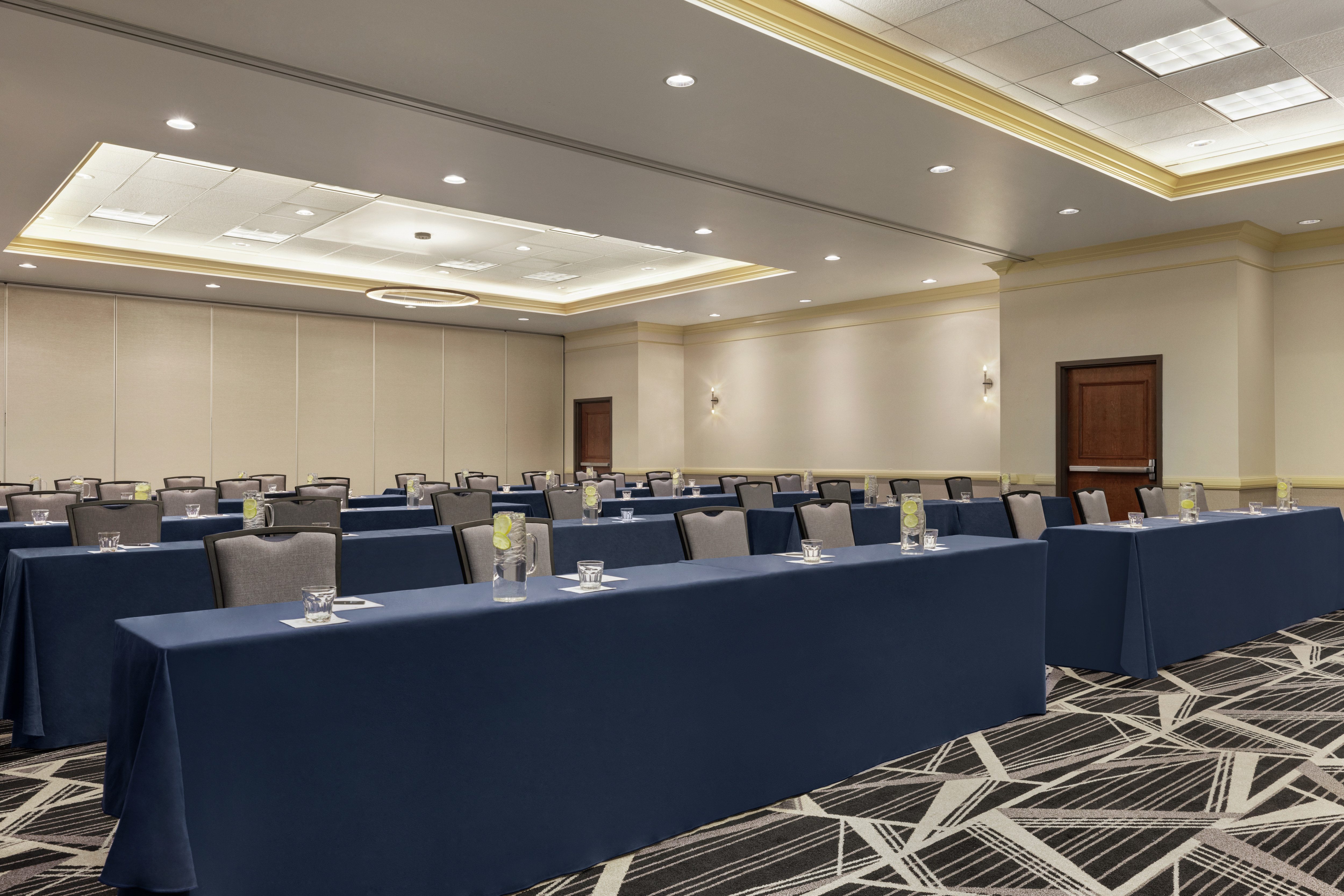 Spacious ballroom on-site featuring classroom style setup for corporate events and functions.